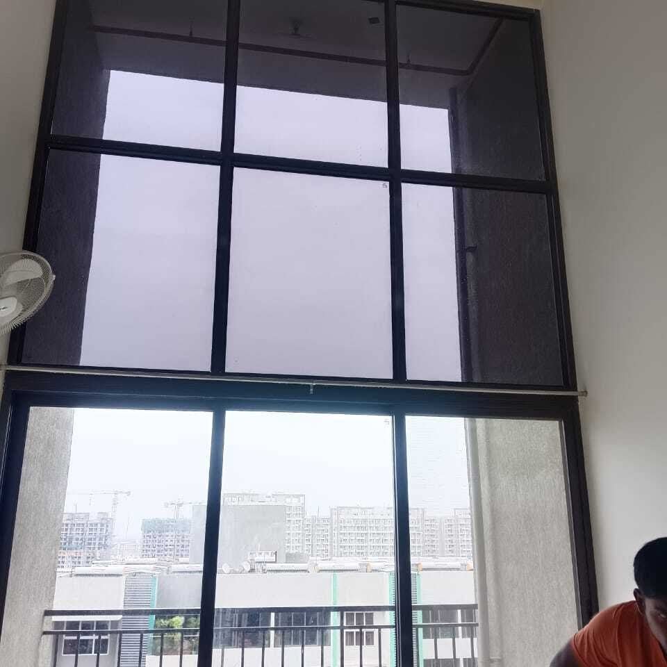 Large black grid window before decorative film work