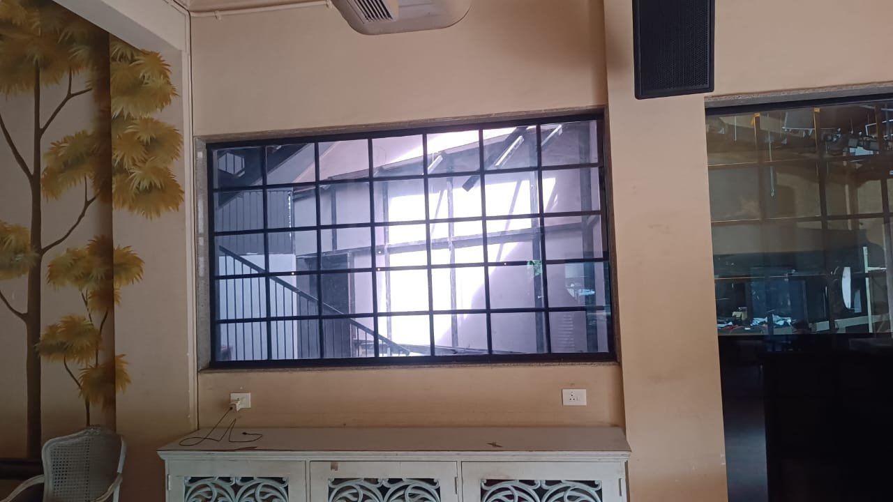 Interior wall and black window grill before film application